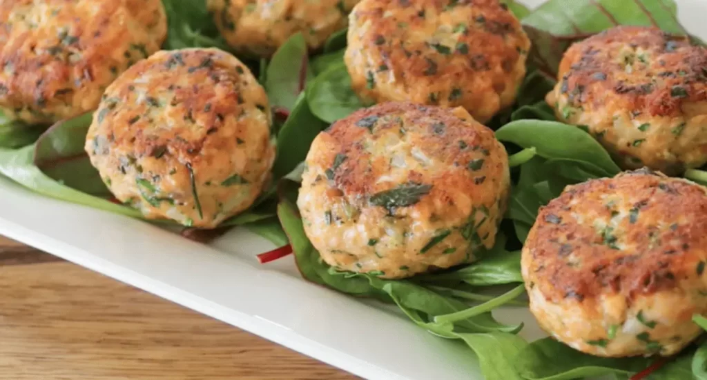 Golden brown salmon cakes on a plate, showcasing the delicious Salmon Cakes Recipe.