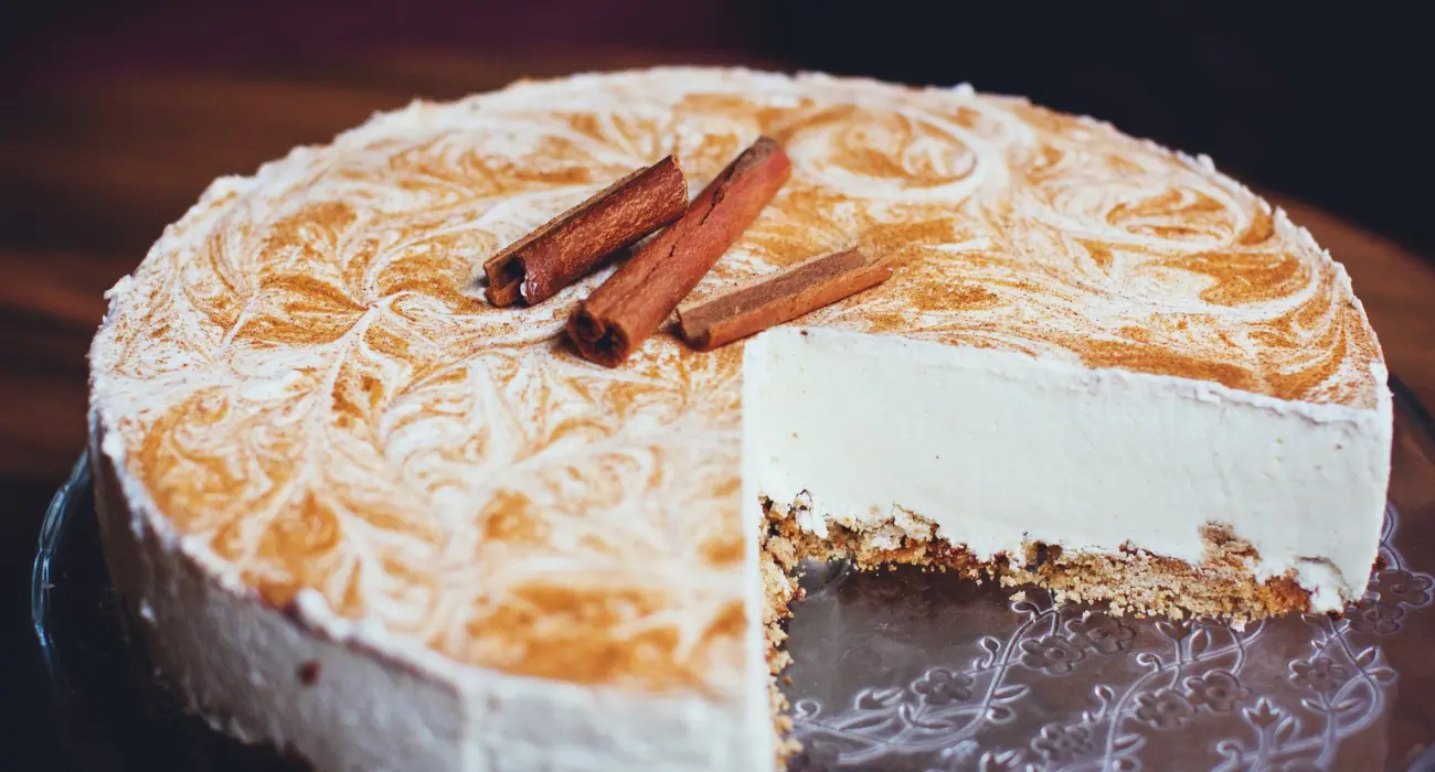 Homemade dog-friendly cake decorated with fresh fruits and a bone-shaped treat on top