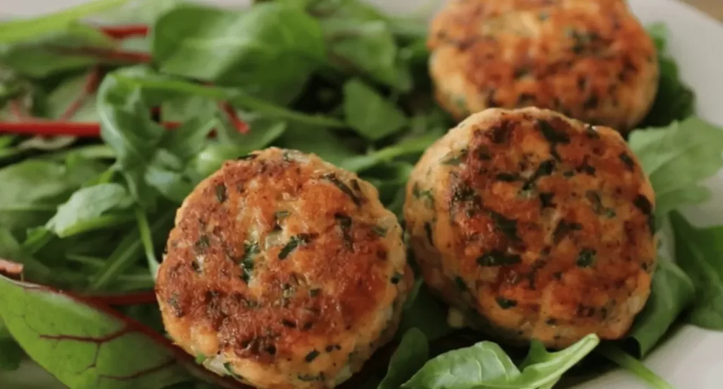 Golden brown salmon cakes on a plate, showcasing the delicious Salmon Cakes Recipe.