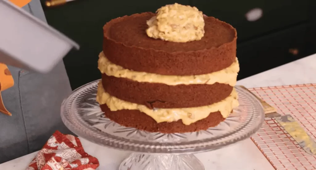 Decorating Marmalade Café German Chocolate Cake with coconut and pecans