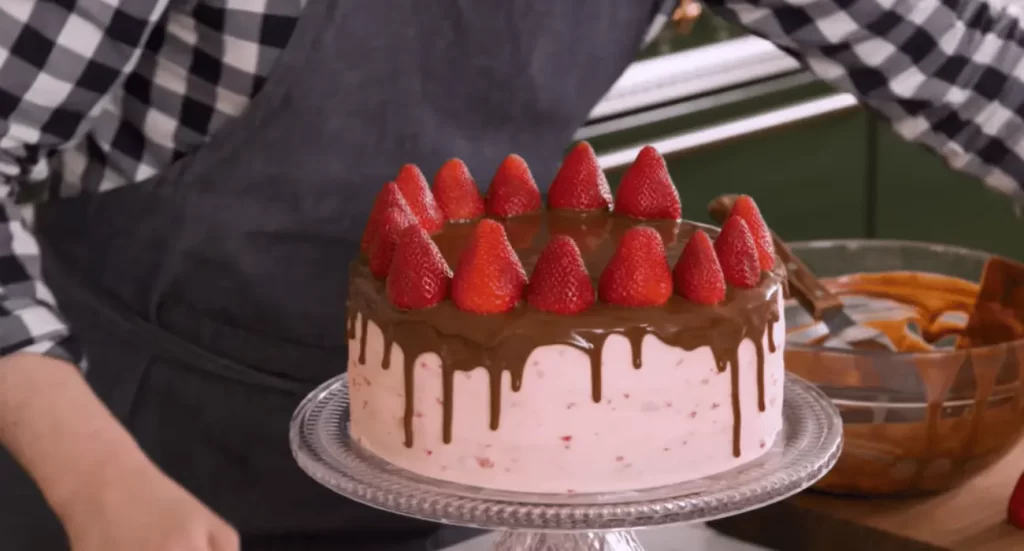 Ingredients for making strawberry chocolate cake, including cocoa powder, fresh strawberries, flour, and sugar. 