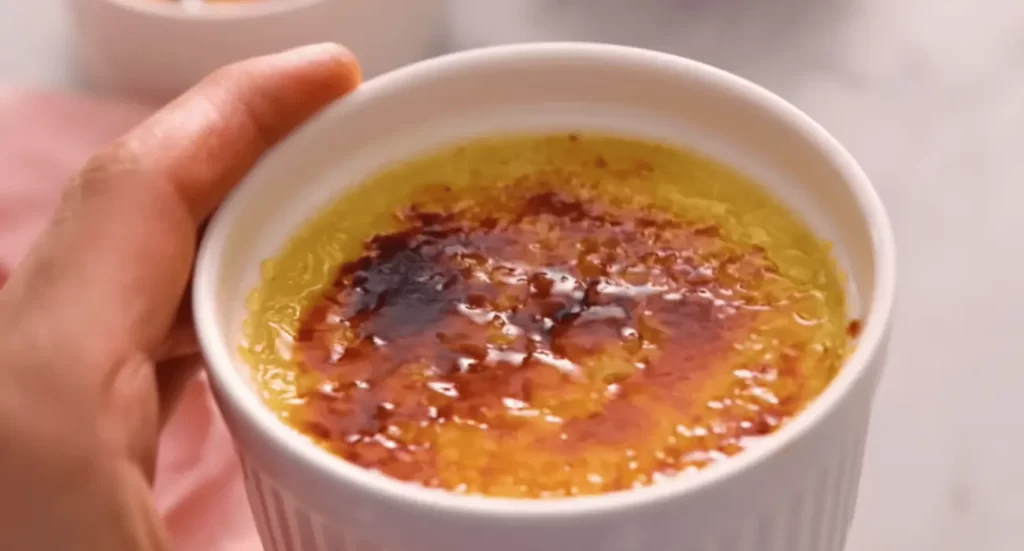 A beautifully plated crab brulee, highlighting the savory twist on the classic crème brûlée with a rich custard base