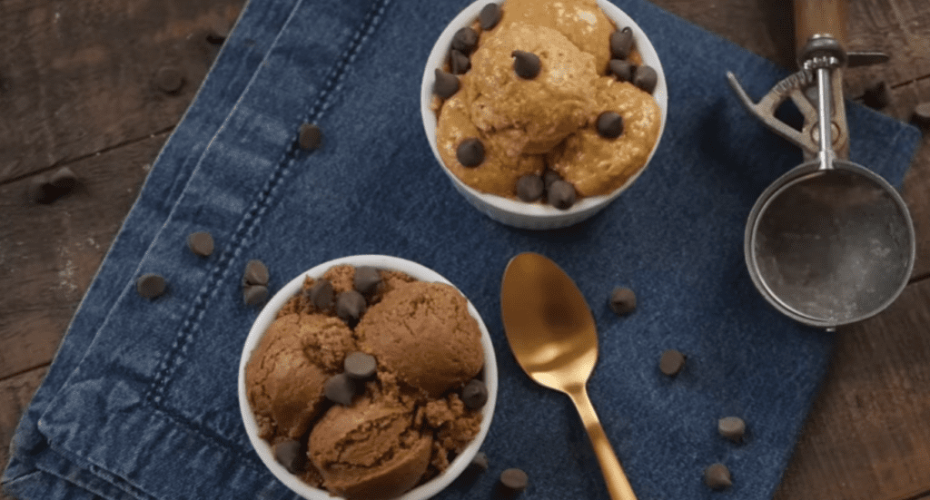 Close-up of a protein cookie with chocolate chips, showcasing its soft, chewy texture and nutritional ingredients. Perfect for a quick, healthy snack.