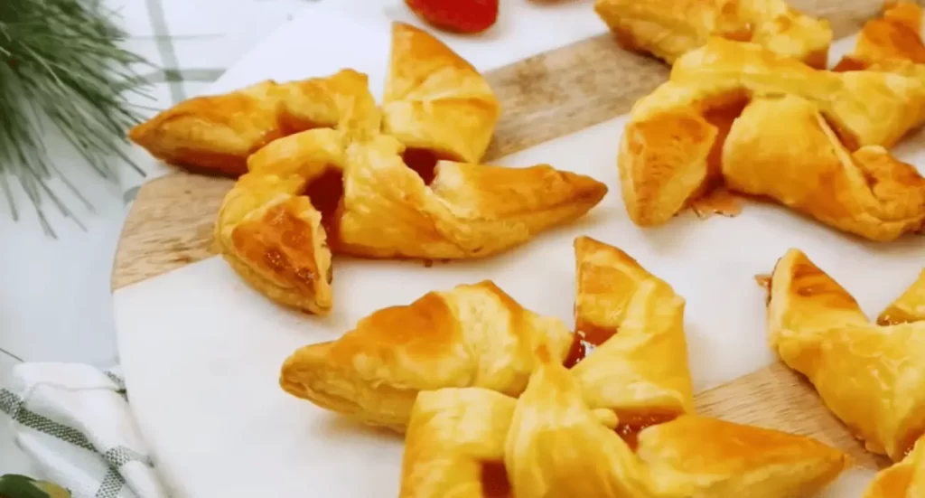 A selection of golden-brown puff pastry desserts, showcasing their flaky layers and sweet fillings