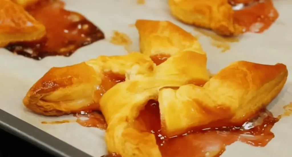 A selection of golden-brown puff pastry desserts, showcasing their flaky layers and sweet fillings