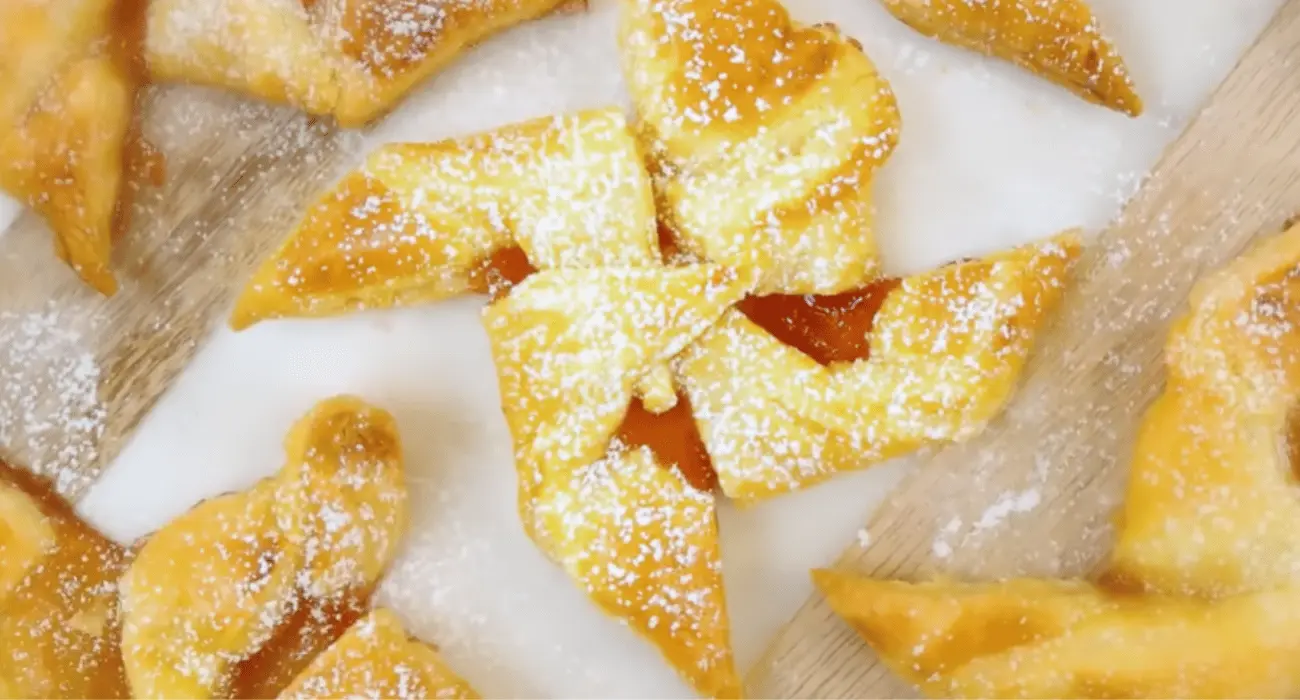 A selection of golden-brown puff pastry desserts, showcasing their flaky layers and sweet fillings